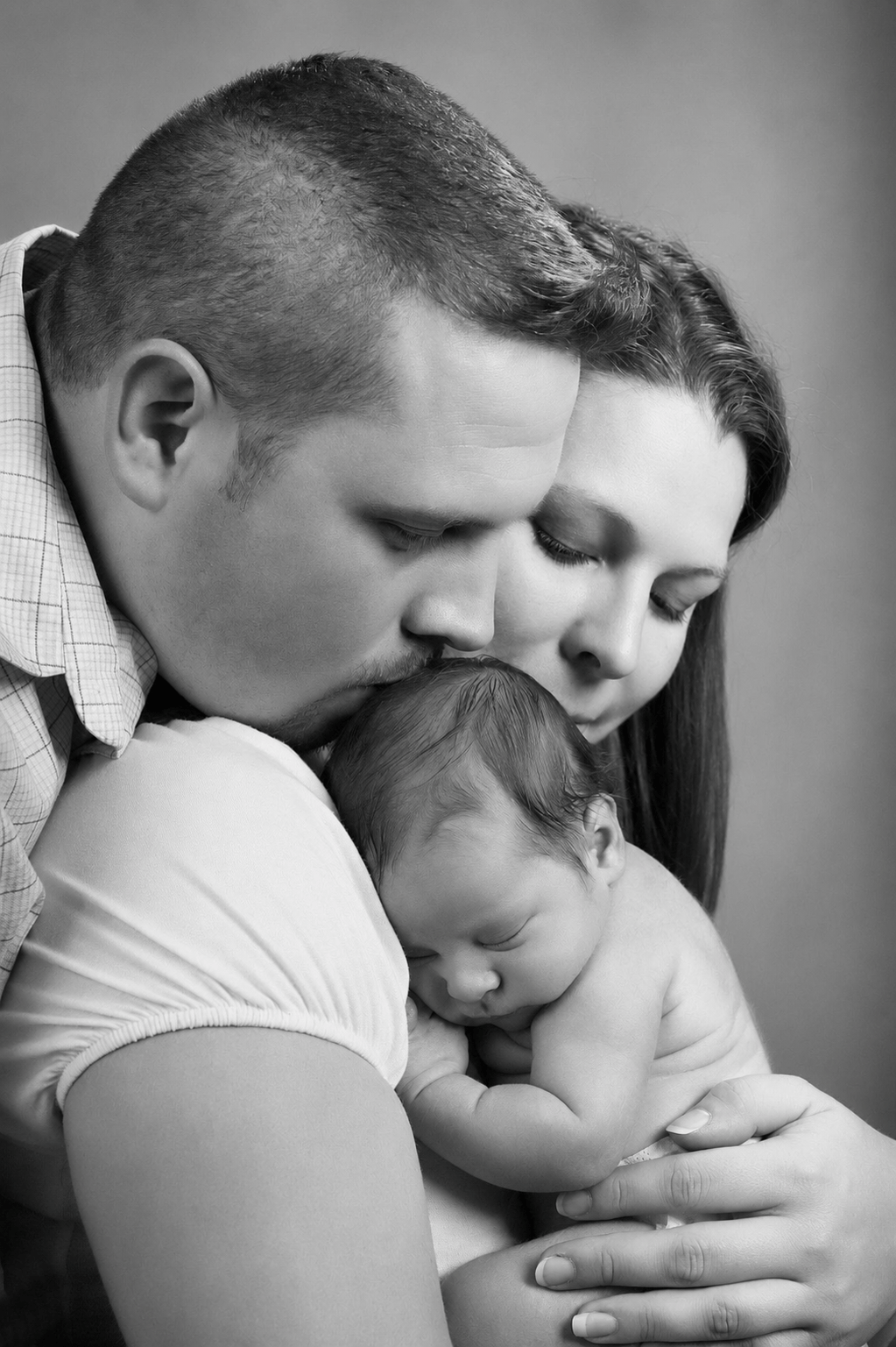 Family portrait — couple with new baby Peter Farrar Portraits Hampshire